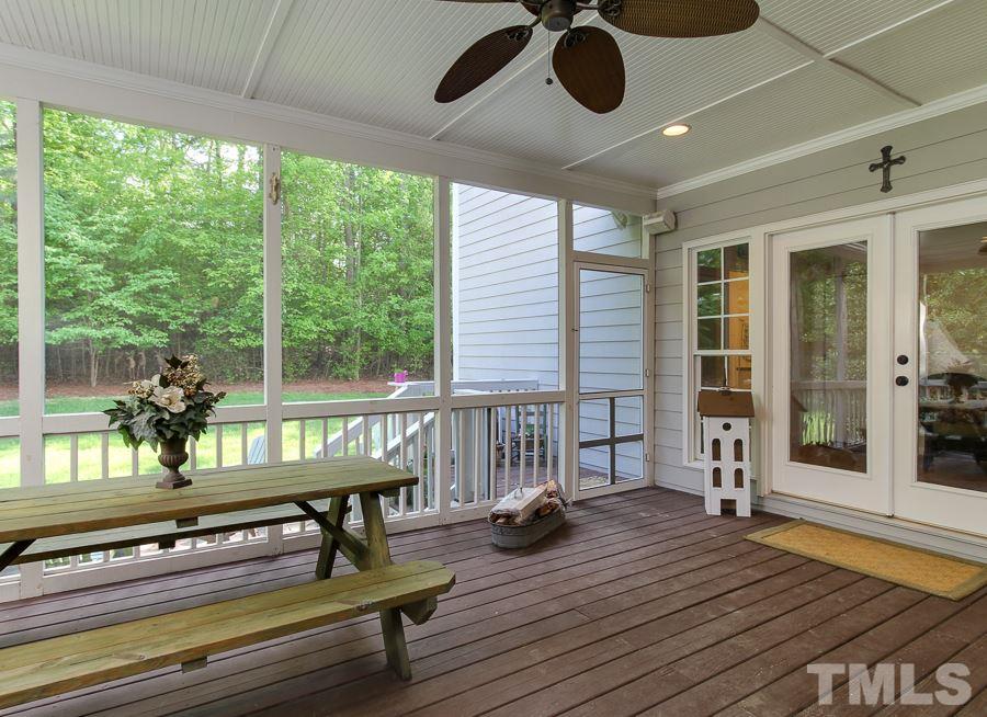 936 Oak Creek Road Raleigh, NC 27615 - Photo 23 of 25 a view of a patio with a table and chairs