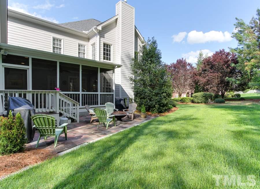 936 Oak Creek Road Raleigh, NC 27615 - Photo 24 of 25 a view of a chair and table in backyard of the house