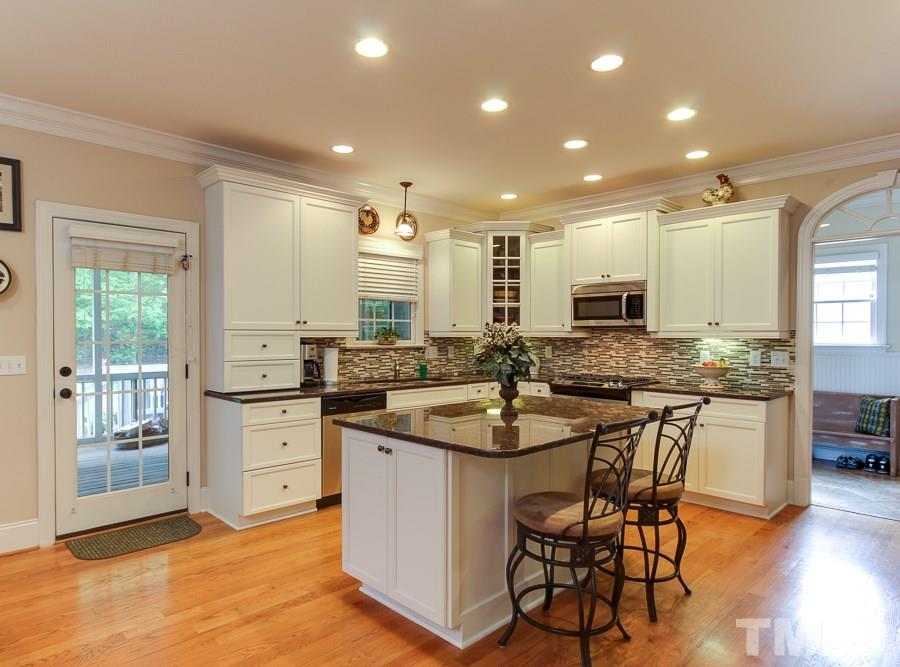 936 Oak Creek Road Raleigh, NC 27615 - Photo 7 of 25 a kitchen with stainless steel appliances kitchen island granite countertop a sink and cabinets