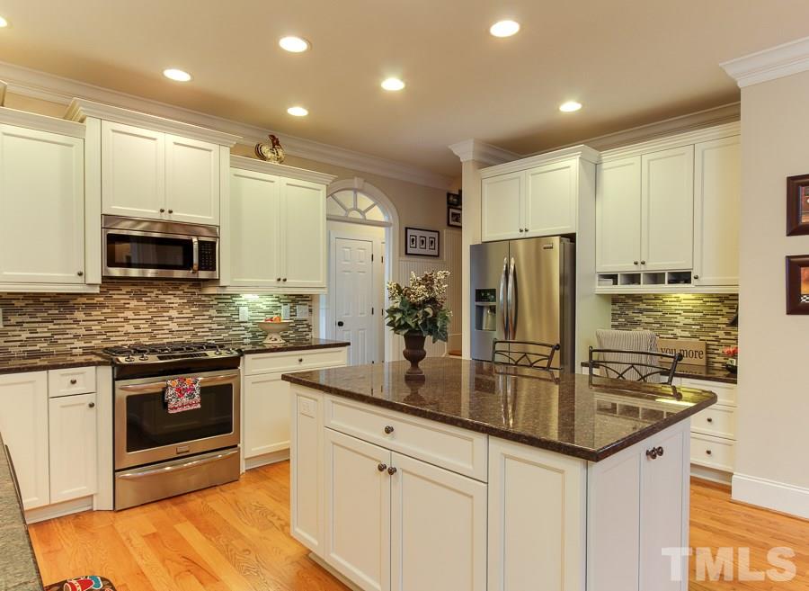 936 Oak Creek Road Raleigh, NC 27615 - Photo 8 of 25 a kitchen with stainless steel appliances granite countertop a sink stove and refrigerator