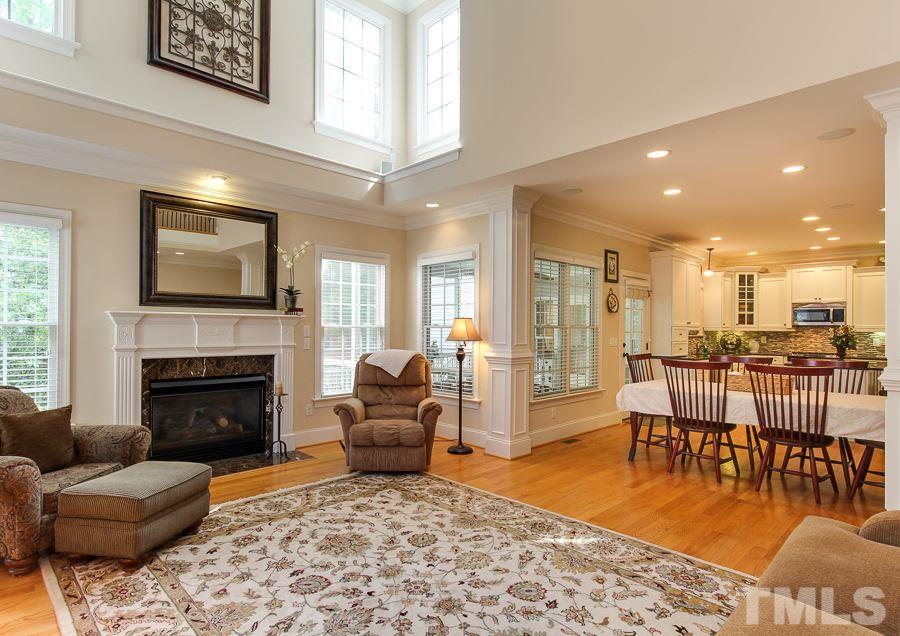 936 Oak Creek Road Raleigh, NC 27615 - Photo 9 of 25 a living room with furniture a fireplace and a flat screen tv