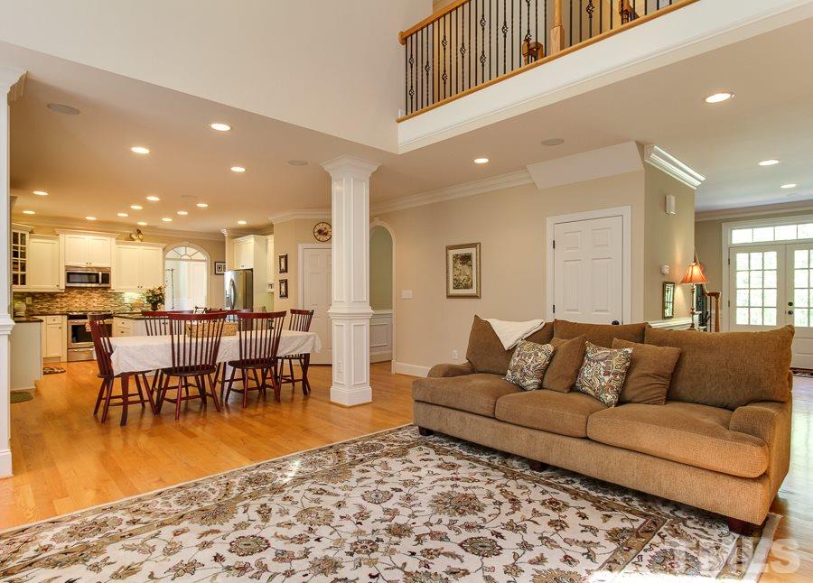 936 Oak Creek Road Raleigh, NC 27615 - Photo 10 of 25 a living room with furniture and a dining table with kitchen view
