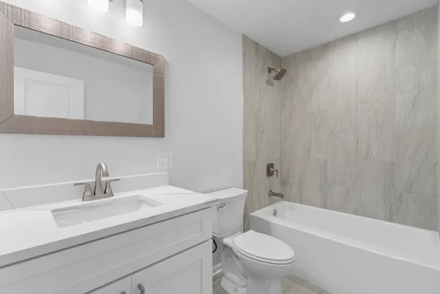 a bathroom with a sink a toilet and a bathtub