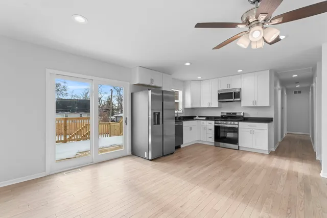 a kitchen with stainless steel appliances a refrigerator sink and cabinets