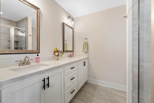 a bathroom with a double vanity sink and mirror