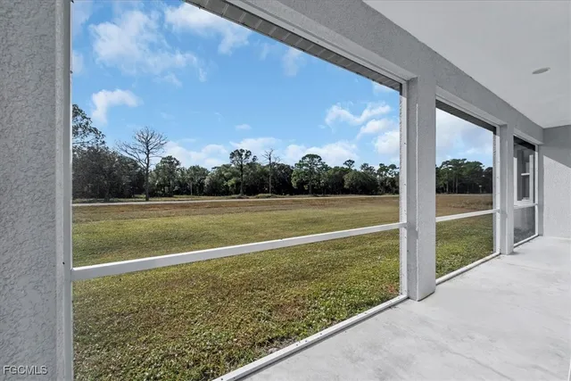 a view of balcony with a floor to ceiling window and a yard