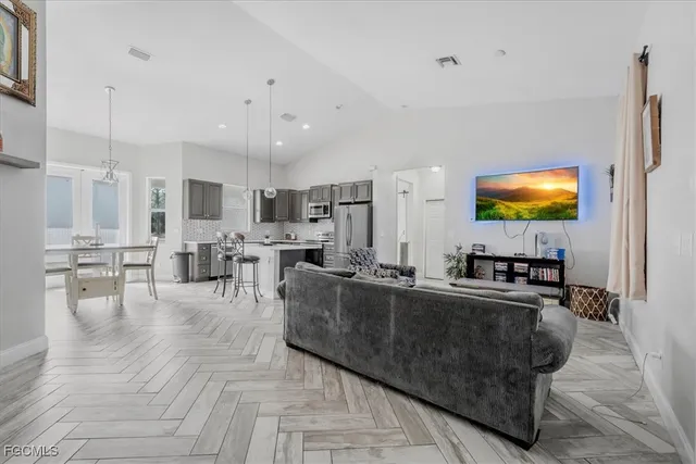 a living room with stainless steel appliances kitchen island granite countertop furniture and a kitchen view