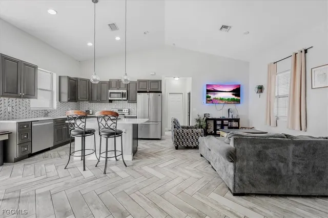 a living room with furniture and a chandelier