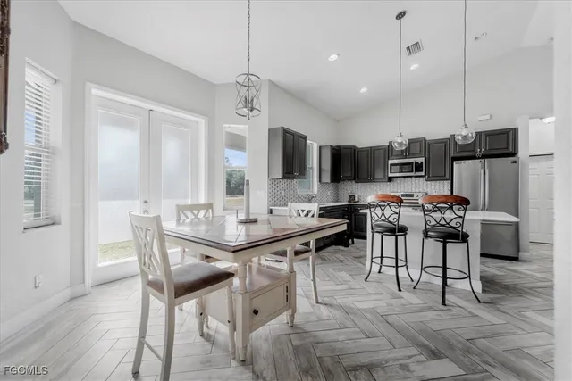 a kitchen with stainless steel appliances granite countertop a stove top oven a sink a refrigerator and a granite counter tops