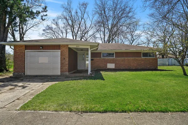 a front view of house with a garden