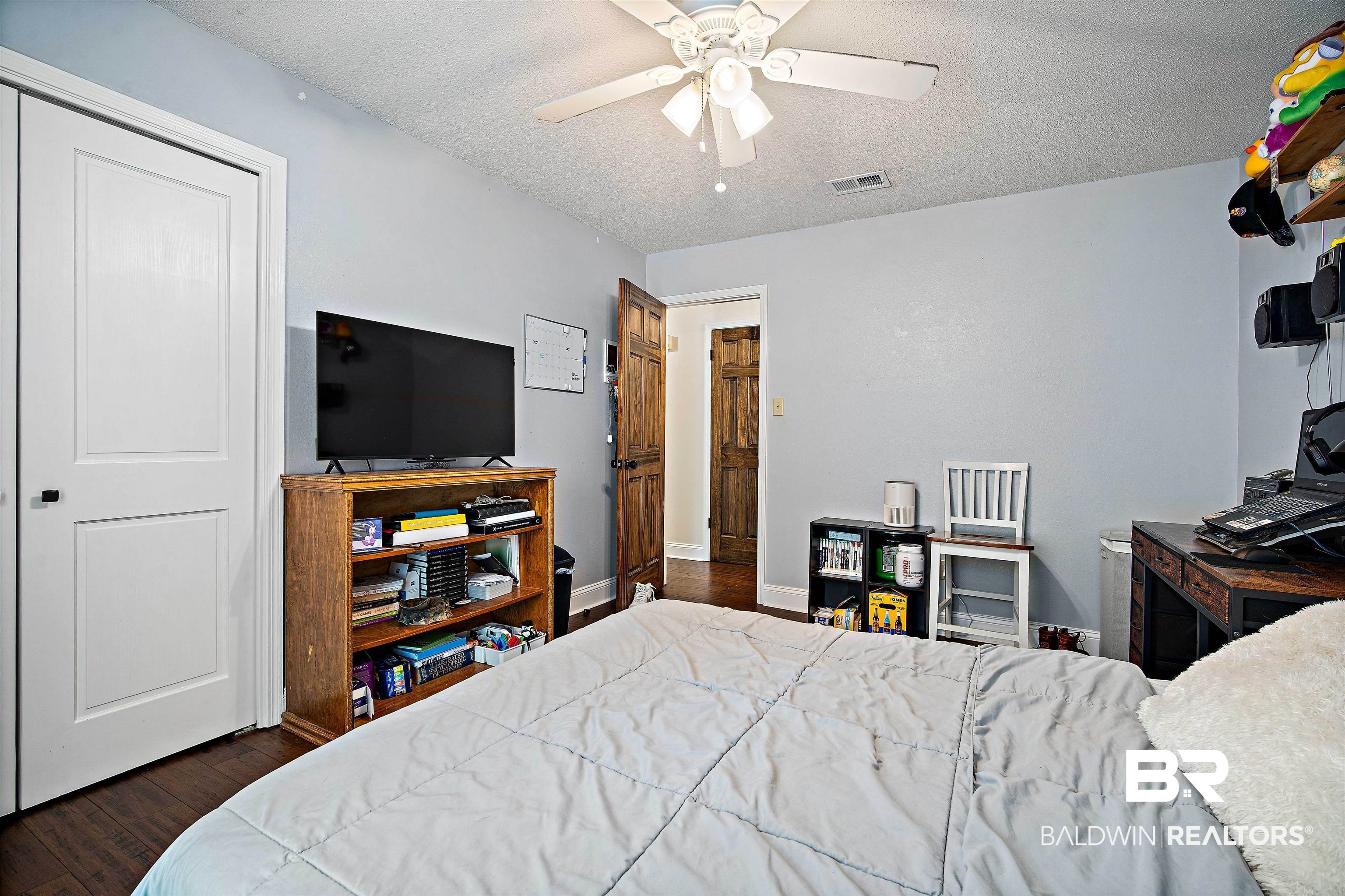 71 Caisson Trace Daphne, AL 36527 - Photo 24 of 36 Spacious room featuring light blue walls, wood-finish flooring, and white trim