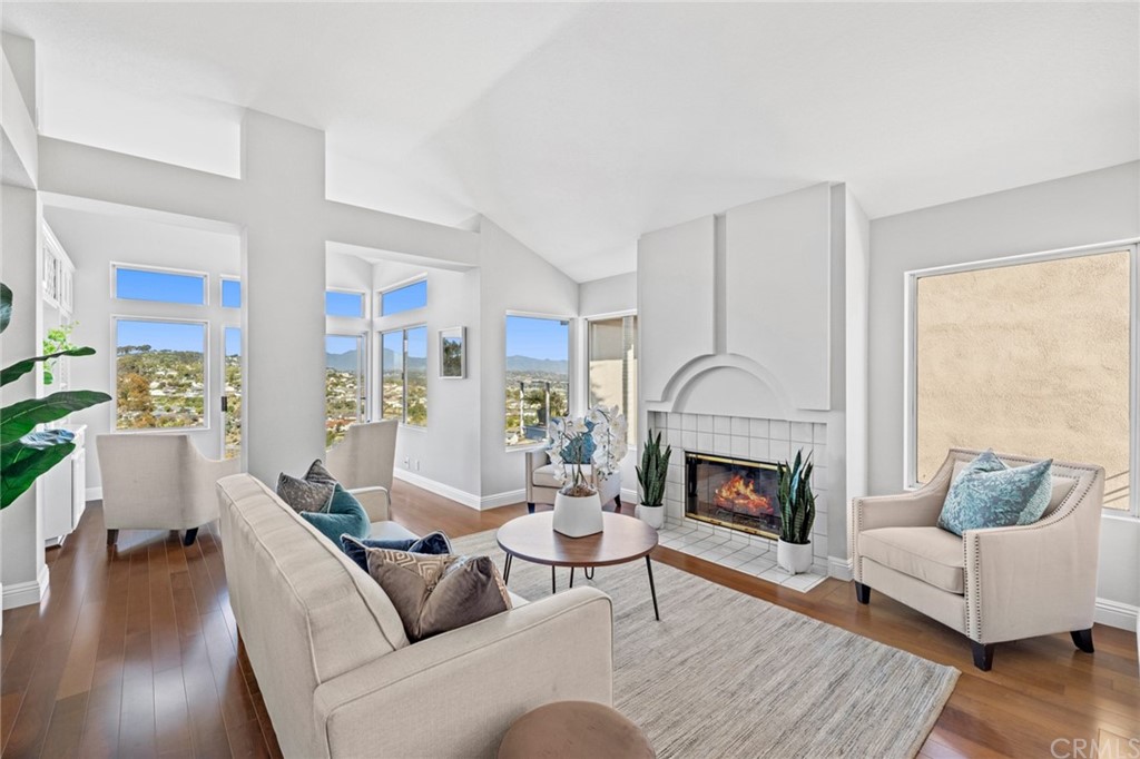24955 Seagate Drive Dana Point, CA 92629 - Photo 11 of 39 a living room with furniture fireplace and wooden floor