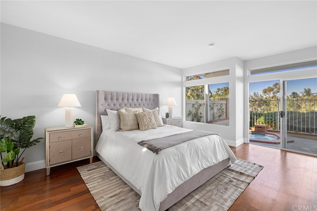 24955 Seagate Drive Dana Point, CA 92629 - Photo 16 of 39 a bedroom with a large bed and a potted plant