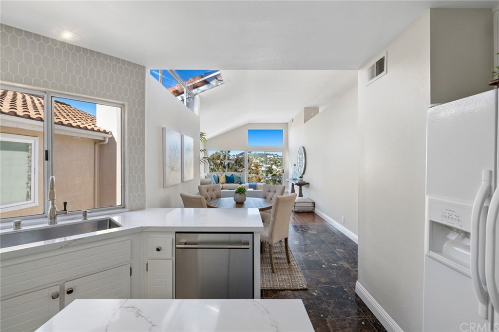 24955 Seagate Drive Dana Point, CA 92629 - Photo 9 of 39 a kitchen with a sink appliances and cabinets