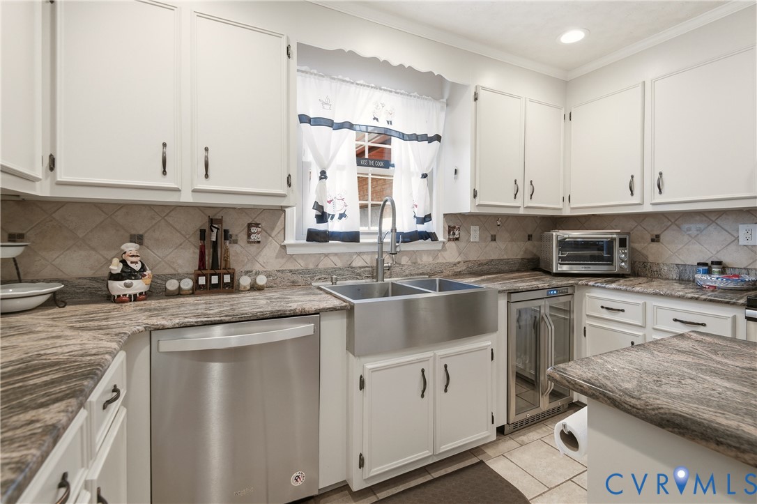 107 Oxford Road Hopewell, VA 23860 - Photo 17 of 50 White cabinetry with dark hardware, stone-look cou