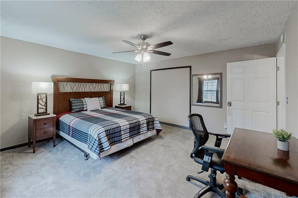 2284 Emerald Springs Drive Decatur, GA 30035 - Photo 10 of 30 a bedroom with a bed a desk and chair