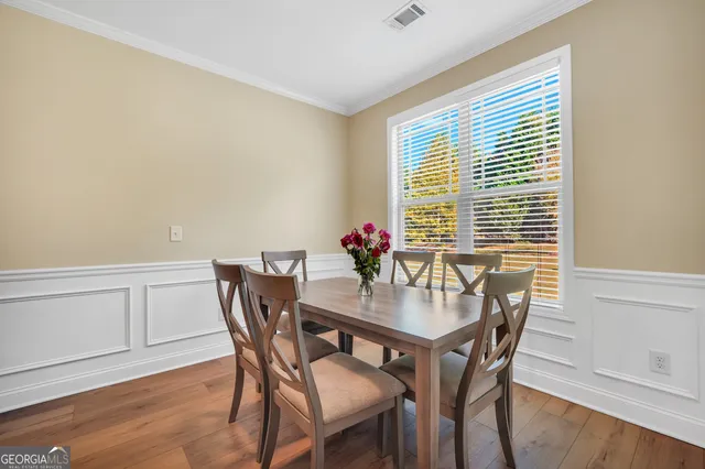 a view of a dining room with furniture and wooden floor