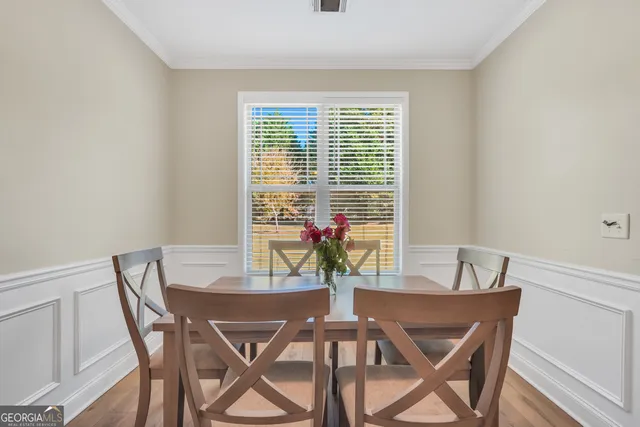 a dining room with furniture and window