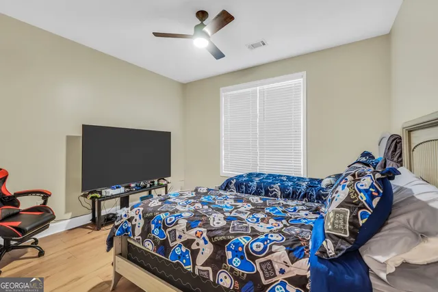 a bedroom with a bed and a flat screen tv