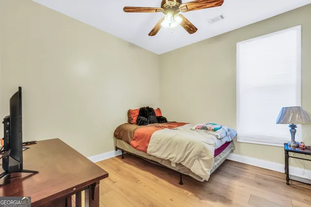 a bedroom with a bed and a desk