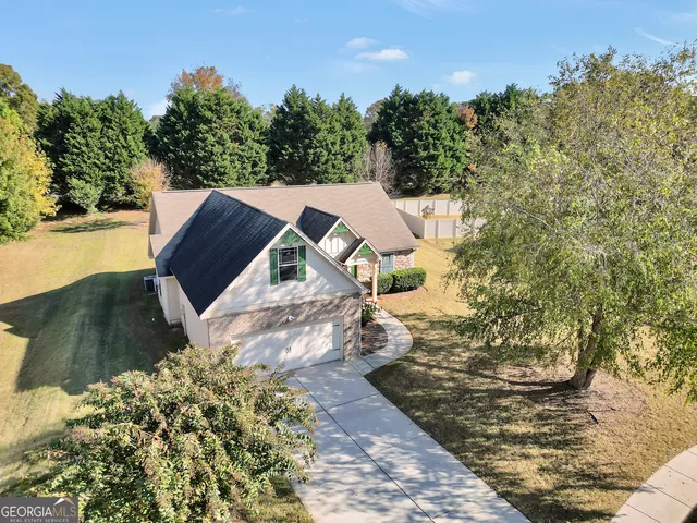 an aerial view of a swimming pool with outdoor seating