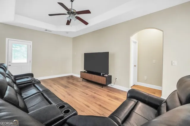 a living room with furniture and a flat screen tv