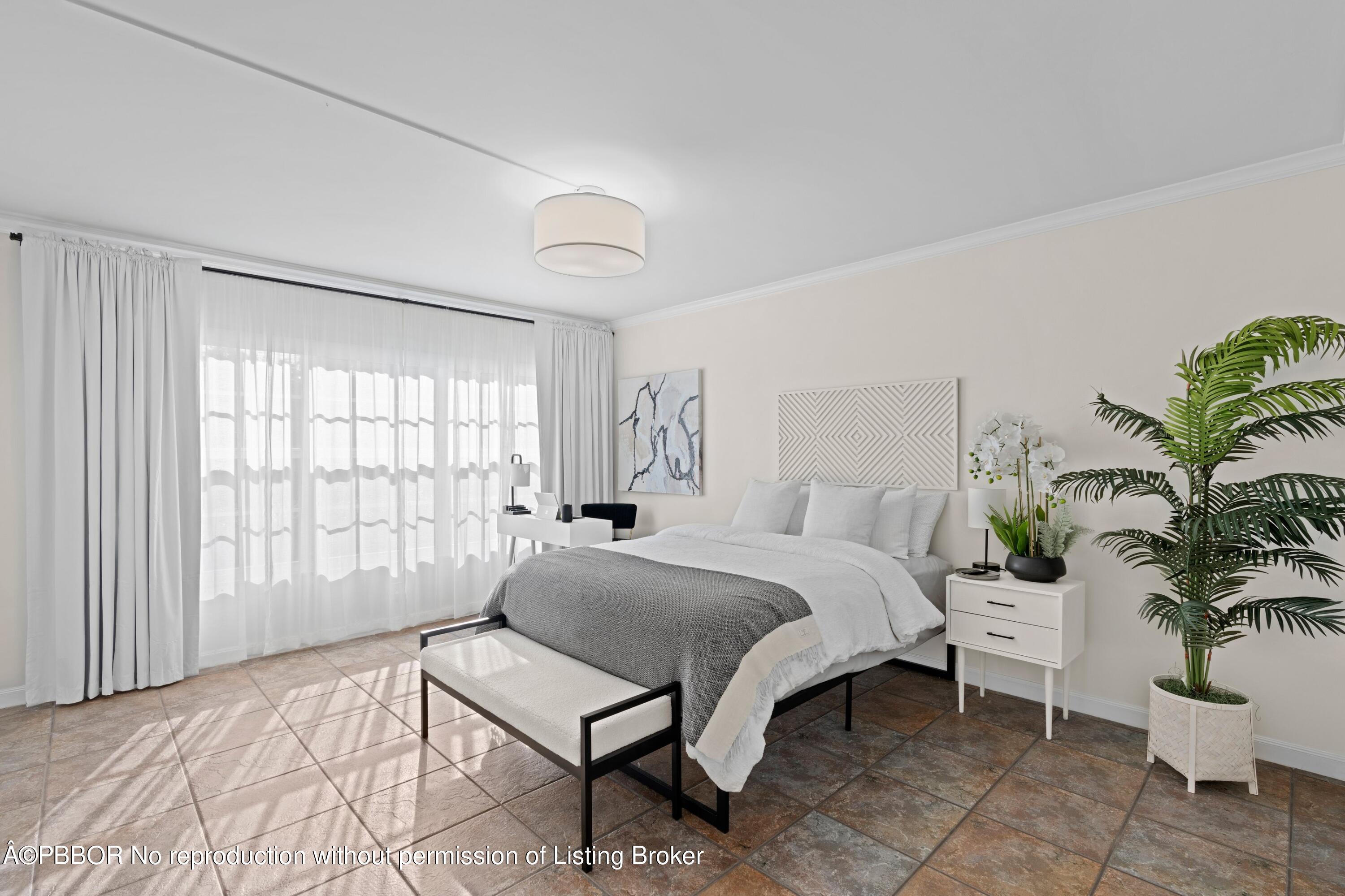 2195 Ibis Isle Road, Unit 1 Palm Beach, FL 33480 - Photo 11 of 38 a bedroom with a bed and large window