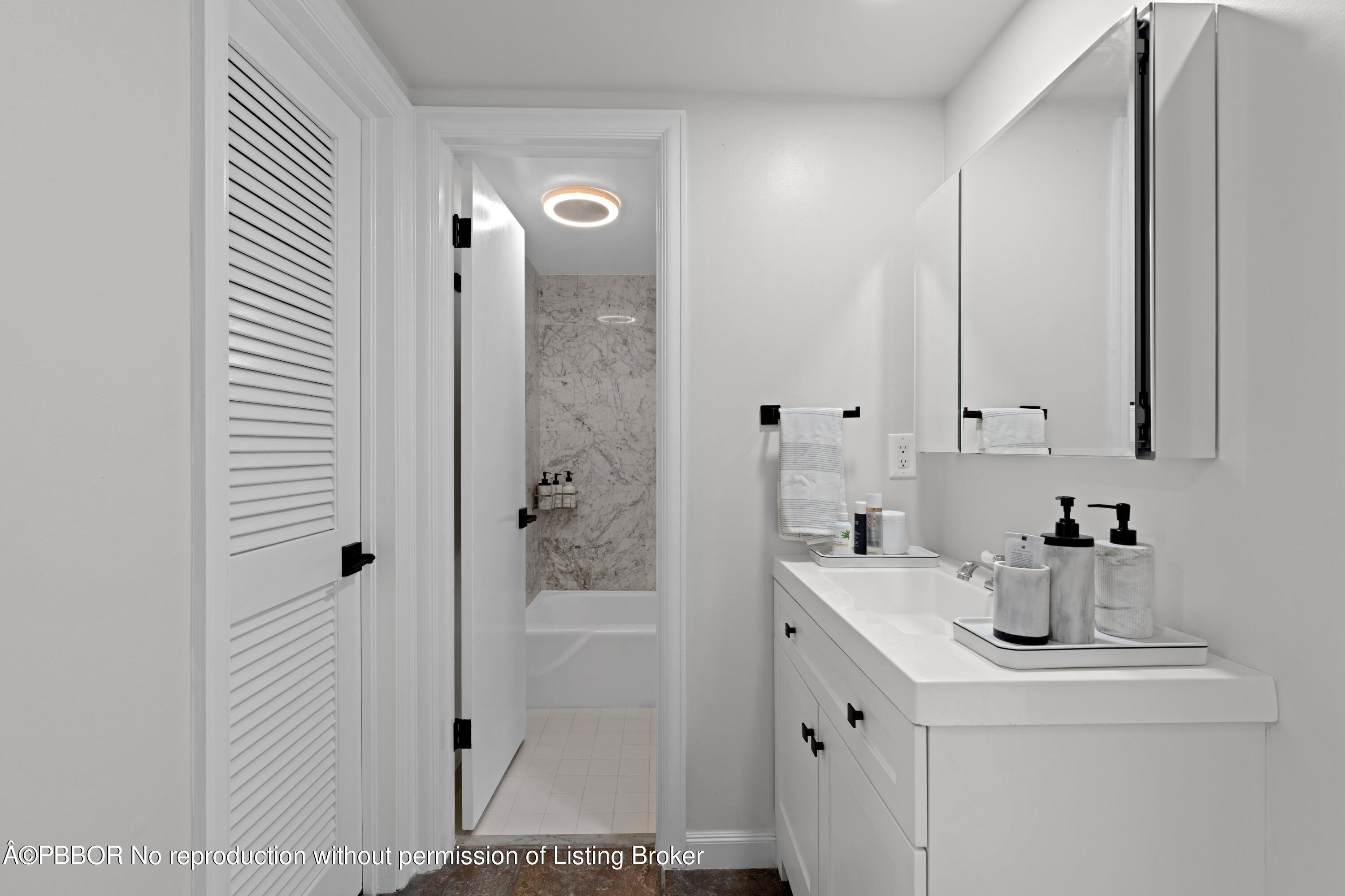 2195 Ibis Isle Road, Unit 1 Palm Beach, FL 33480 - Photo 13 of 38 a bathroom with a sink and a mirror