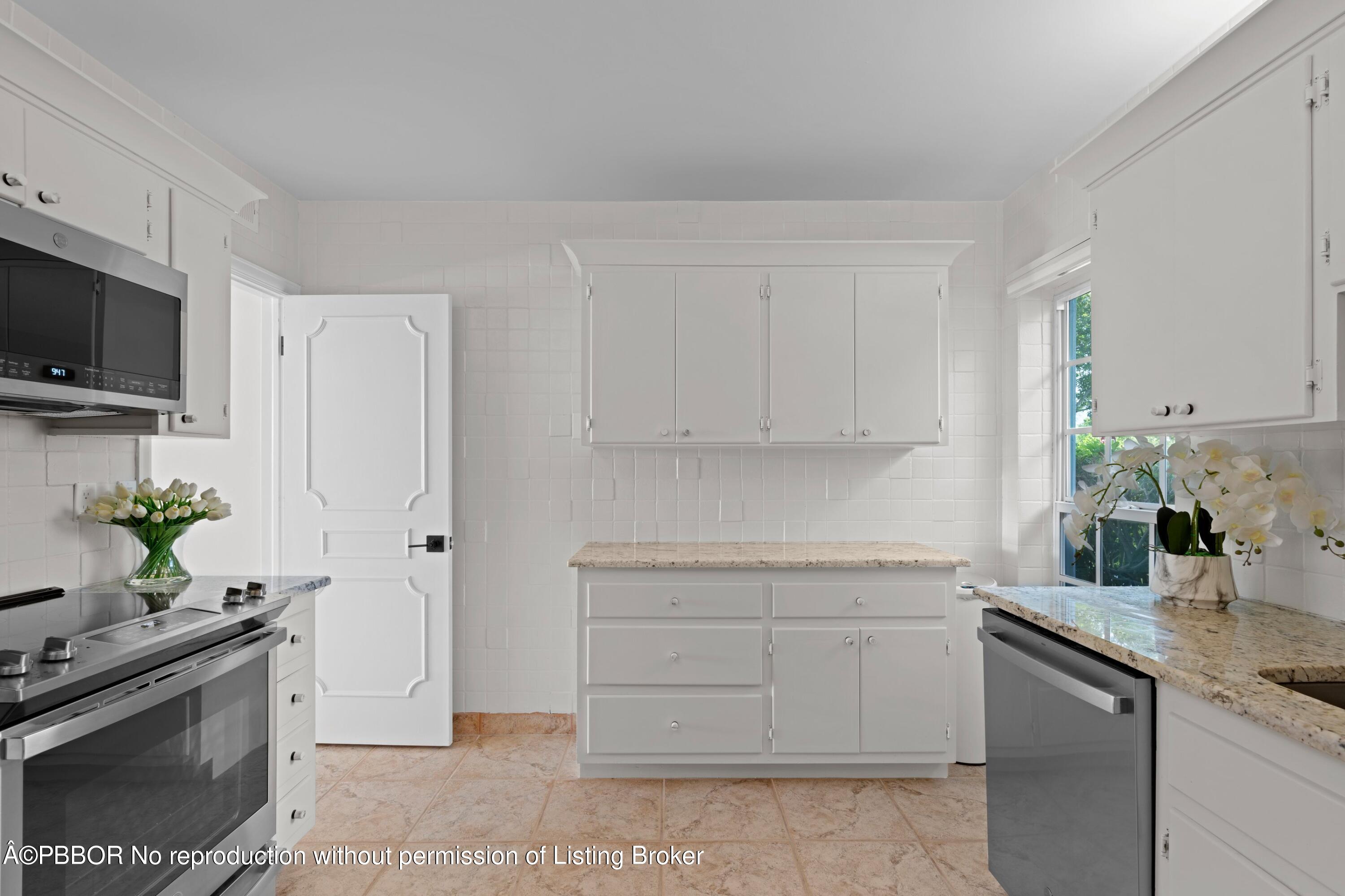2195 Ibis Isle Road, Unit 1 Palm Beach, FL 33480 - Photo 19 of 38 a kitchen with stainless steel appliances white cabinets and a sink