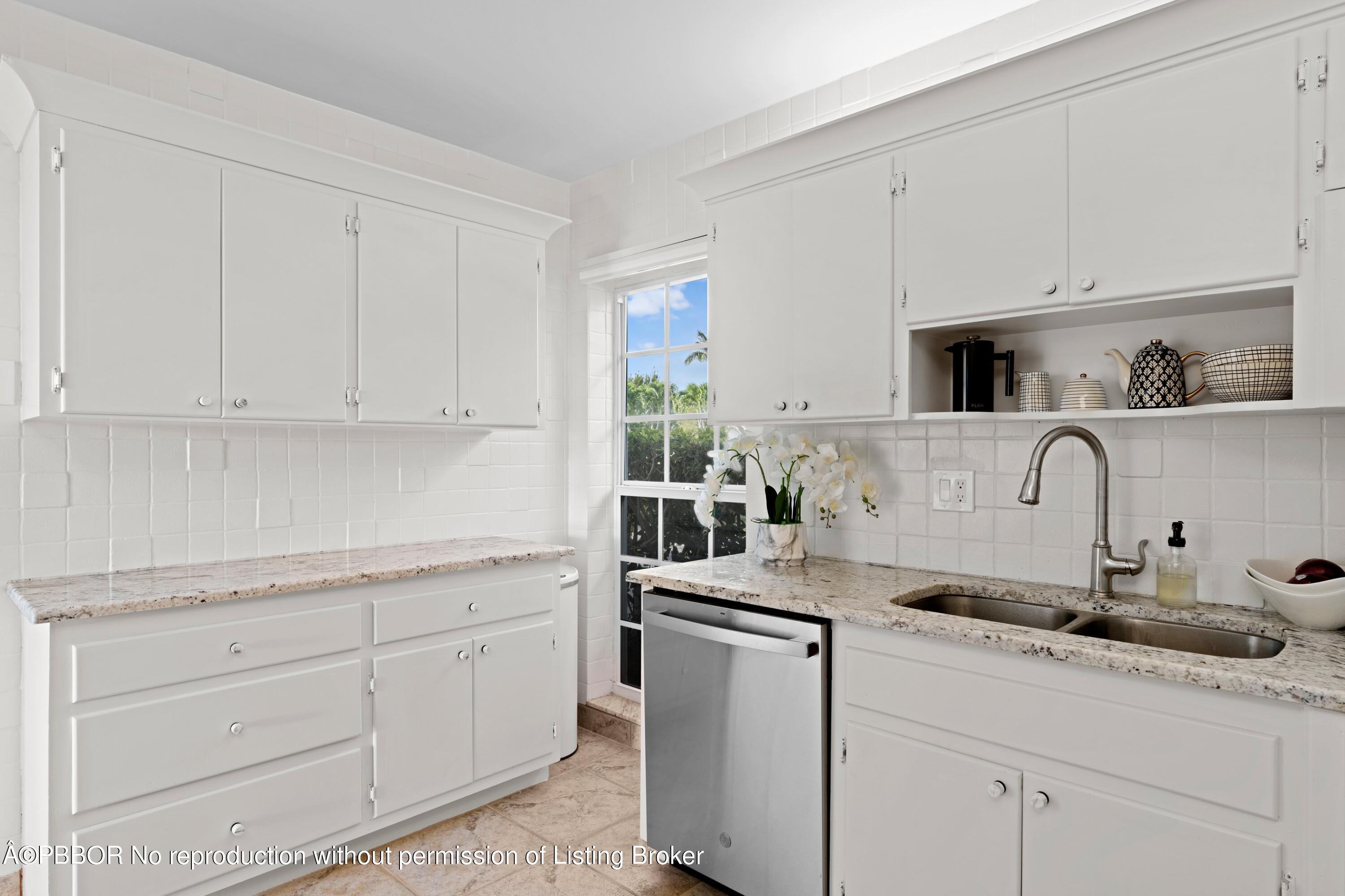 2195 Ibis Isle Road, Unit 1 Palm Beach, FL 33480 - Photo 20 of 38 a kitchen with white cabinets and sink
