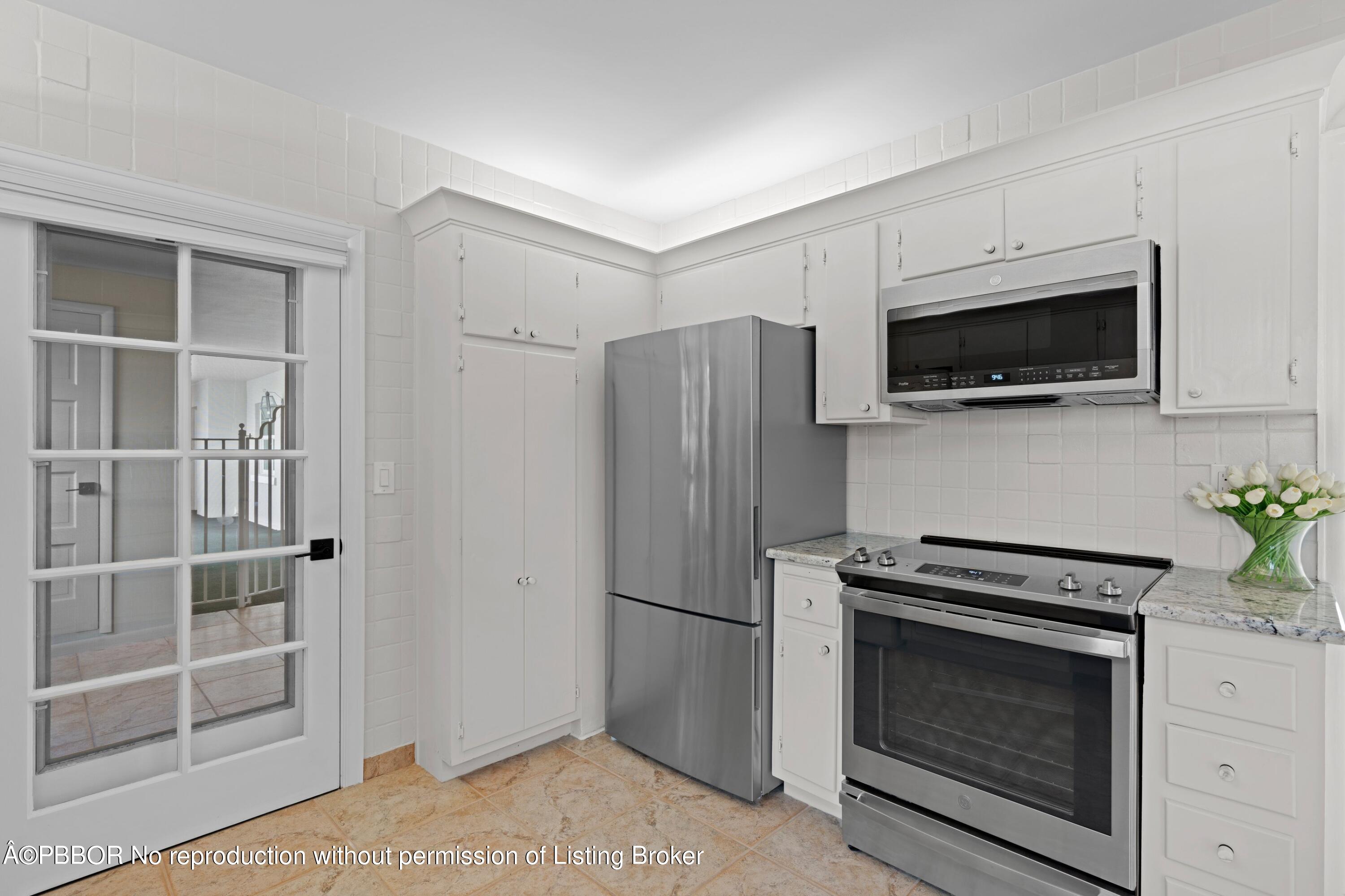 2195 Ibis Isle Road, Unit 1 Palm Beach, FL 33480 - Photo 21 of 38 a kitchen with a refrigerator stove and microwave