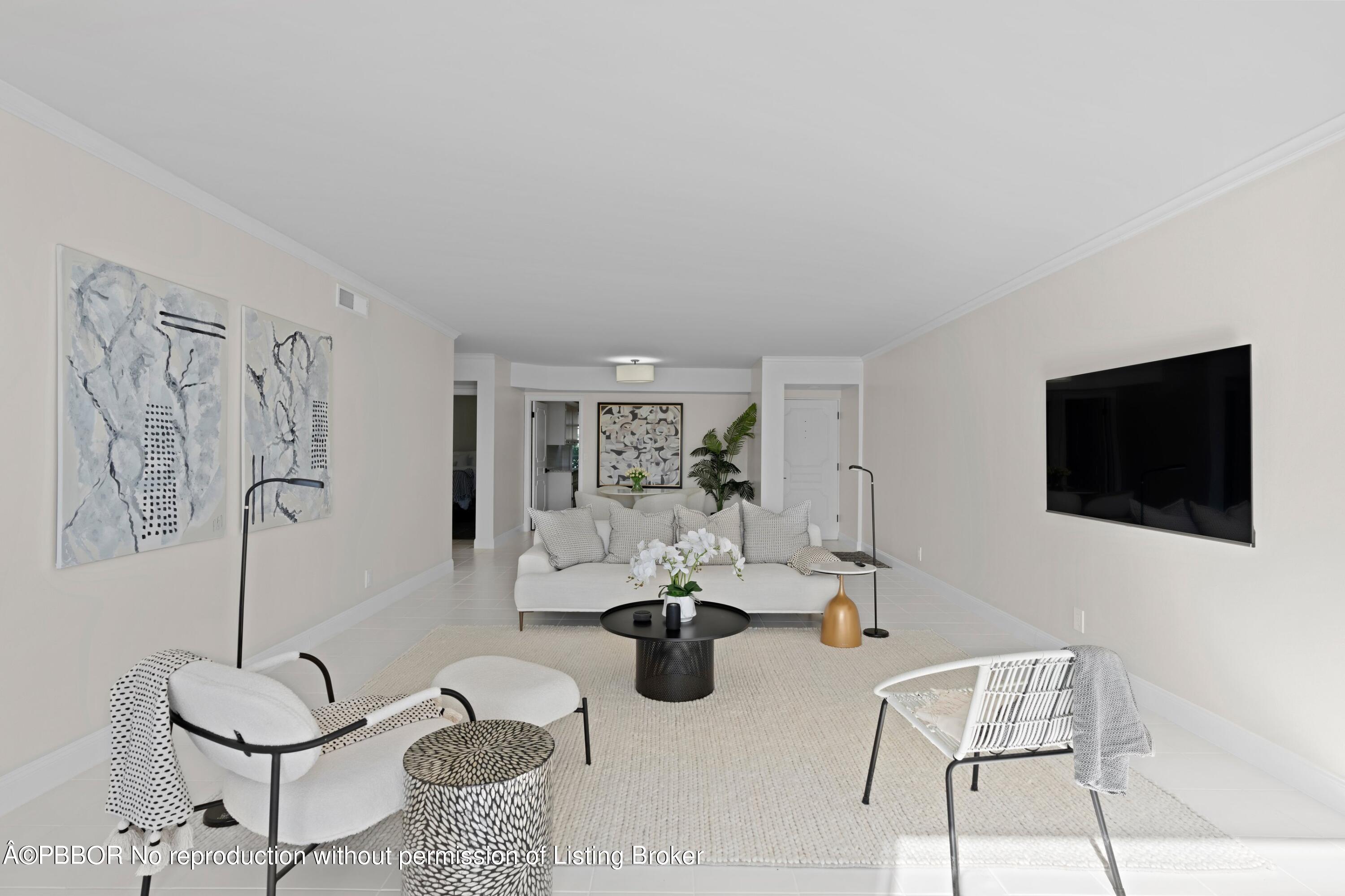 2195 Ibis Isle Road, Unit 1 Palm Beach, FL 33480 - Photo 7 of 38 a living room with furniture and a flat screen tv