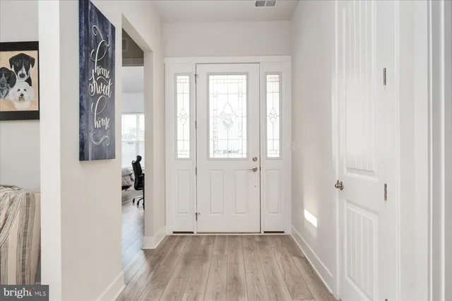 a living room with furniture and a view of kitchen