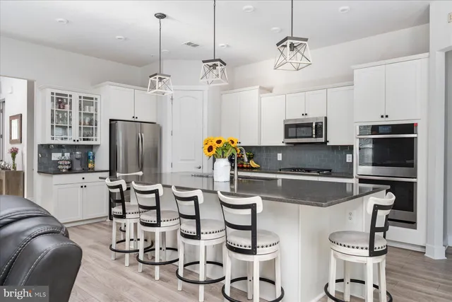 a bathroom with a tub shower vanity and a sink