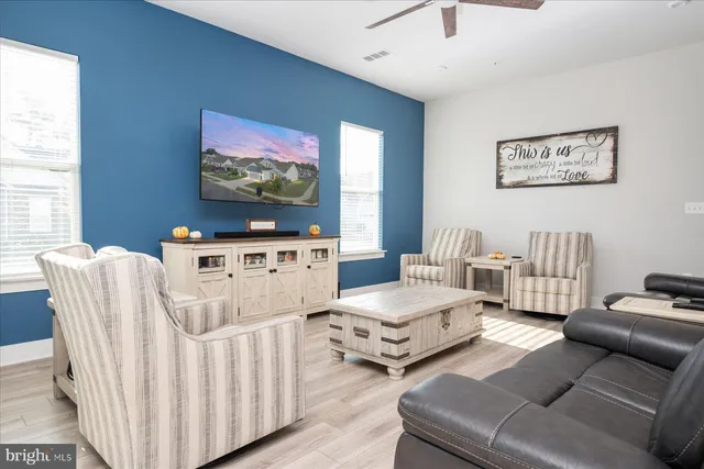 a bathroom with a granite countertop toilet sink and mirror