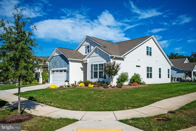 an aerial view of residential houses with outdoor space and swimming pool