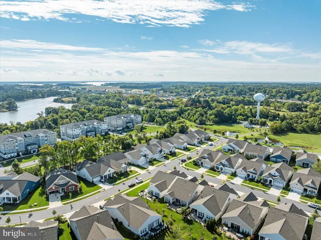 a living room with furniture a fireplace and a large window