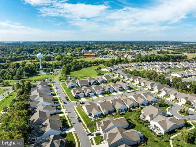 an aerial view of a house with a garden and lake view