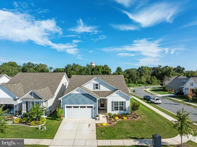 an aerial view of a swimming pool with outdoor seating
