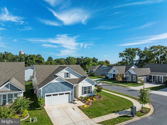 a view of a hallway with wooden floor and closet