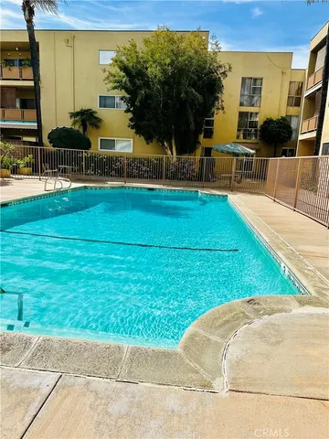 a view of backyard with swimming pool