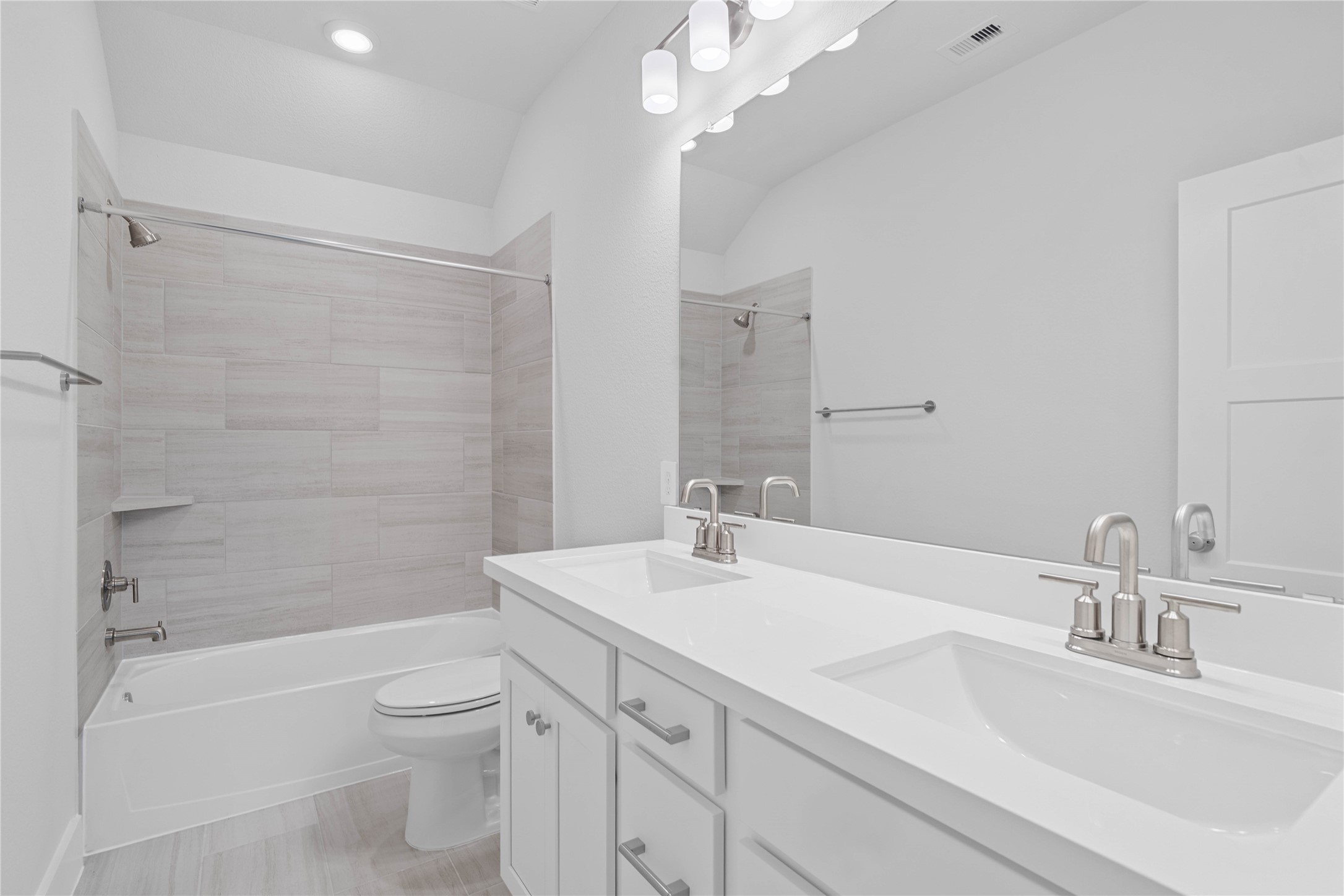 2035 Frst Strm Way Conroe, TX 77304 - Photo 38 of 45 A streamlined secondary bathroom providing a functional tub/shower combination, double sinks, and modern fixtures, seamlessly blending practicality and style.