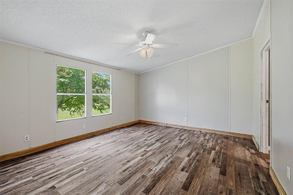 150 Gilbreath Road Sadler, TX 76264 - Photo 25 of 34 a view of an empty room with wooden floor and a window