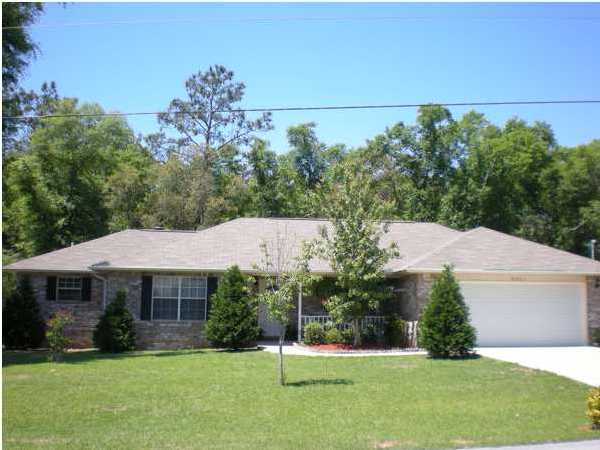 4821 Acorn Drive Crestview, FL 32539 - Photo 1 of 25 a front view of a house with a yard
