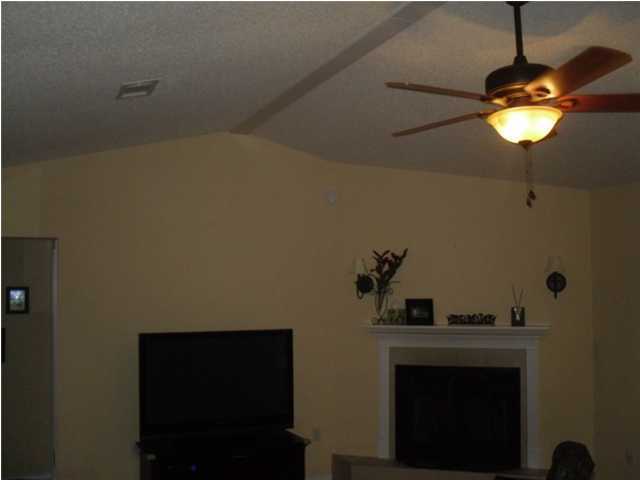4821 Acorn Drive Crestview, FL 32539 - Photo 2 of 25 a room with a fireplace and a ceiling fan