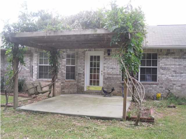4821 Acorn Drive Crestview, FL 32539 - Photo 11 of 25 a front view of a house with a yard