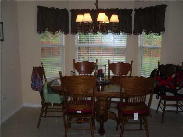 4821 Acorn Drive Crestview, FL 32539 - Photo 3 of 25 a view of a dining room with furniture and wooden floor