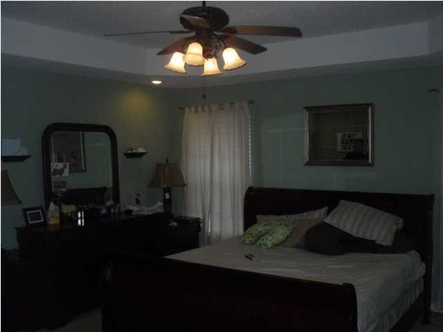 4821 Acorn Drive Crestview, FL 32539 - Photo 22 of 25 a bedroom with a bed and a chandelier