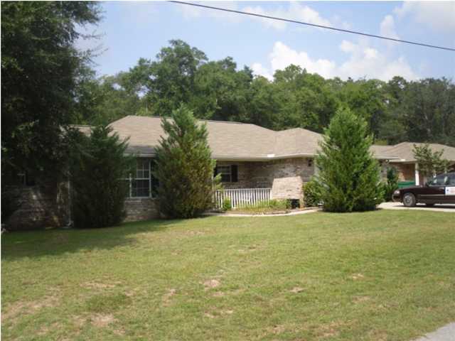 4821 Acorn Drive Crestview, FL 32539 - Photo 7 of 25 a front view of a house with a yard and garage