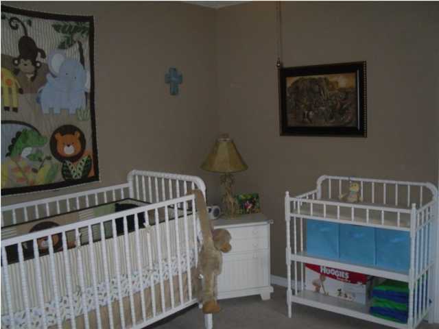 4821 Acorn Drive Crestview, FL 32539 - Photo 10 of 25 a bedroom with furniture and baby crib